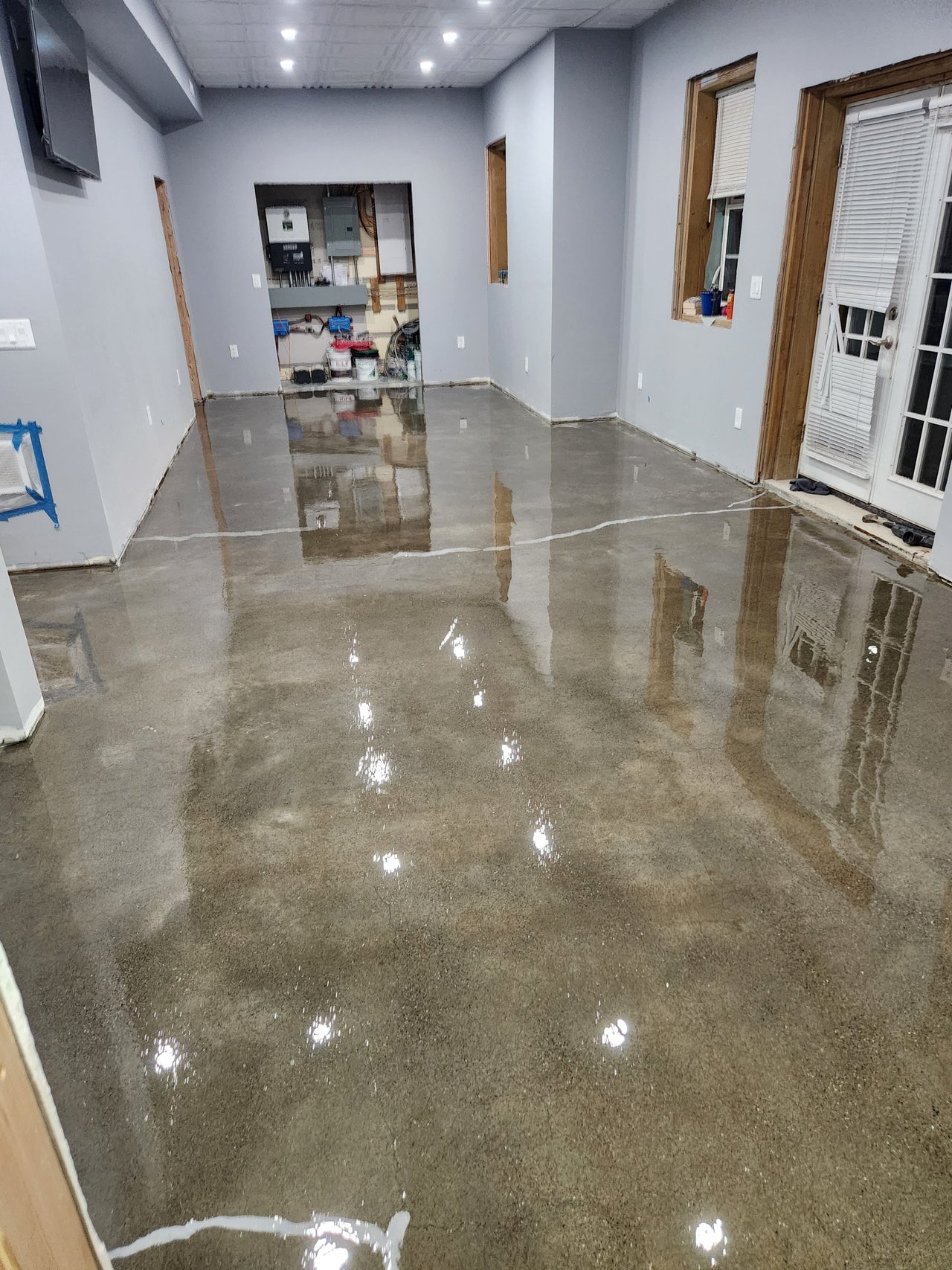 Industrial concrete floor application of a 25 lb rated moisture vapor barrier epoxy, providing a self leveling and protective base for resinous flooring.