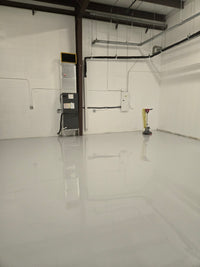 Thumbnail for High-gloss light gray 100% solids industrial epoxy floor coating in a large commercial warehouse