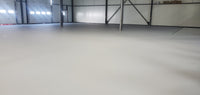 Thumbnail for Large industrial warehouse interior featuring a seamless concrete floor protected with AQUALAB PUR Matte water-based urethane topcoat for a durable, non-glare finish.