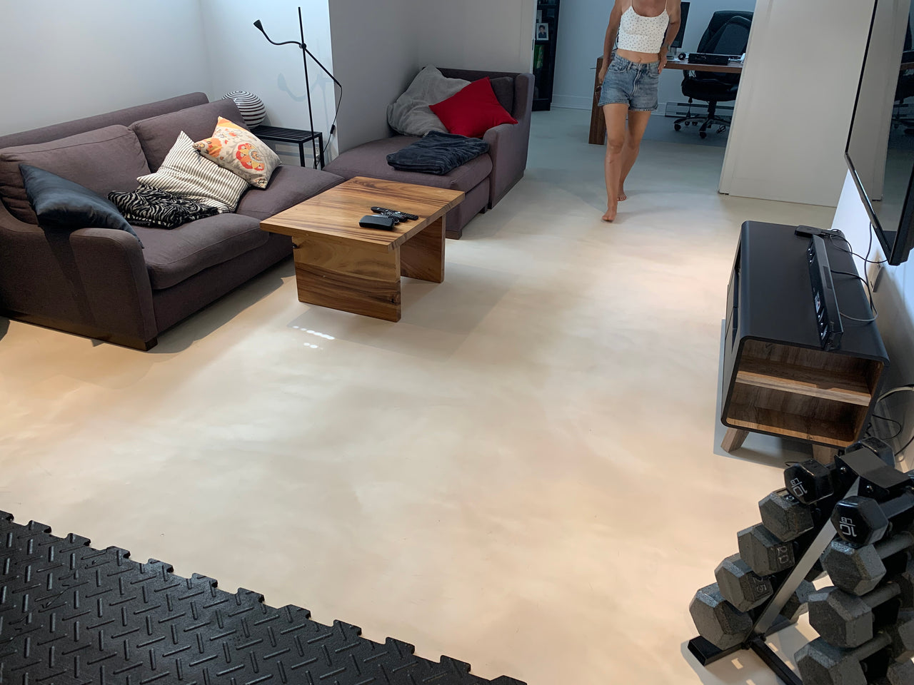 Modern residential living room featuring a Pearl Metallic epoxy floor finished with AQUALAB PUR Matte water-based urethane for a smooth, non-reflective surface.