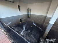 Thumbnail for metallic garage floor installation with gold and white veining over a deep black base, providing a reflective and durable surface.