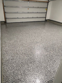 Thumbnail for Full flake Domino garage floor system with a LabSurface LABPOX 30 Light Concrete base and a high-gloss topcoat.