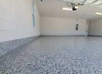 Thumbnail for Full flake garage floor with matching wall coves, utilizing a rapid-curing self leveling epoxy base for professional one-day installations