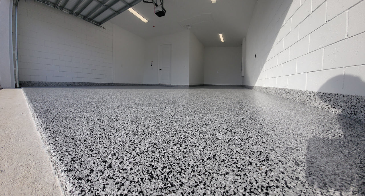 Full flake garage floor and matching coves installed over a self leveling 100% solids fast cure epoxy base.