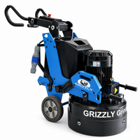 Thumbnail for Side view of the Grizzly Grinders Momma Bear planetary concrete floor grinder showing the blue frame, black motor, side handle, and Grizzly logo against a white background.