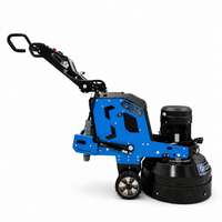 Thumbnail for Side profile view of the Grizzly Grinders Pappa Bear planetary concrete floor grinder featuring a blue steel frame, black motor housing, control handle, and wheels against a white background.