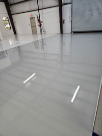 Thumbnail for Lite Gray self-leveling industrial grade 100% solids epoxy floor coating installed in a large commercial warehouse.