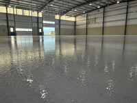 Thumbnail for Large industrial warehouse with a high-gloss, light-reflective floor using LABFENDER Aliphatic Polyurethane for superior abrasion and chemical resistance.