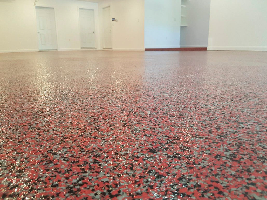 Interior room featuring a decorative red, black, and grey full broadcast flake floor system sealed with Labfast 85 (+) high-gloss polyaspartic coating.