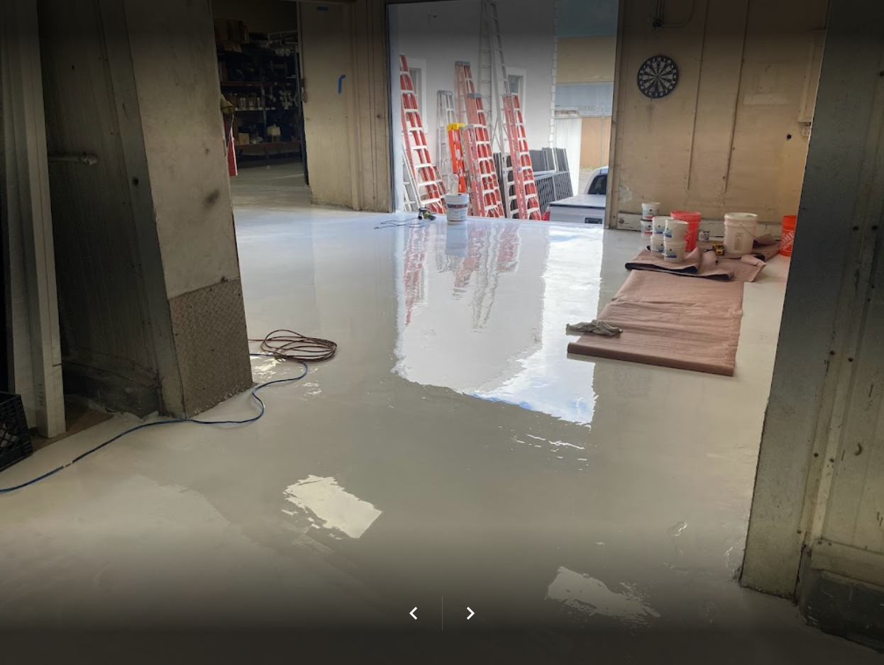 A high-gloss white Labpox 35 epoxy floor installation in progress, showing the reflective finish and professional coating tools.