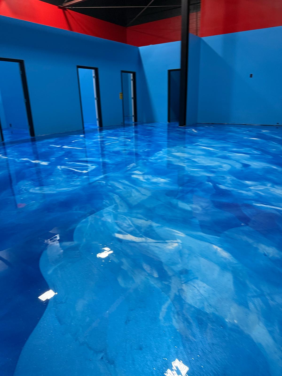 High-gloss commercial floor featuring LABPOX 40 UV Resistant Epoxy with a custom Rainbow Blue, Flash Ice Blue and Ultra Sparkle white, finish for a reflective, iridescent look.