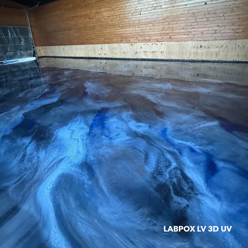 Deep blue and silver metallic epoxy floor using LABPOX LV 3D UV finished with AQUALAB water-based urethane for a smooth, multi-dimensional surface.