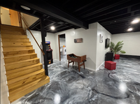 Thumbnail for Modern basement with a custom metallic epoxy floor featuring a blend of Black Pearl, Satin Gray, and Bright White pigments finished with a LABFENDER Aliphatic Polyurethane topcoat.