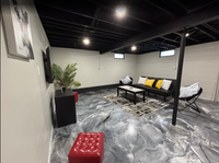 Thumbnail for Modern finished basement featuring a custom metallic epoxy floor with a blend of Black Pearl, Satin Gray, and Bright White pigments, protected by a LABFENDER Aliphatic Polyurethane topcoat.