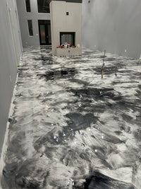 Thumbnail for Modern residential hallway featuring a high-gloss white and charcoal metallic epoxy floor with a marble-swirl finish