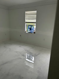 Thumbnail for Seamless high-gloss white and gray marble effect epoxy floor in a contemporary residential living space.