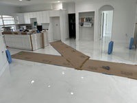 Thumbnail for Modern kitchen featuring a seamless silver marbled epoxy floor with a high-gloss, food-safe protective finish.