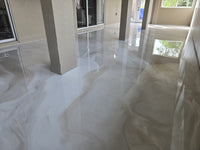 Thumbnail for Residential interior featuring a seamless white and tan metallic epoxy floor with a high-gloss marble effect using LABPOX 40.