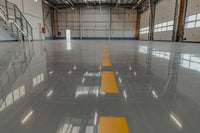Thumbnail for Large-scale industrial warehouse application of Lite Gray self leveling 100% solids epoxy showing a seamless, high-build finish on concrete.