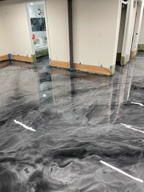 Modern silver and grey metallic epoxy floor with a high-gloss reflective finish and custom flowing marble patterns using Metallic Dream 100% solids epoxy.