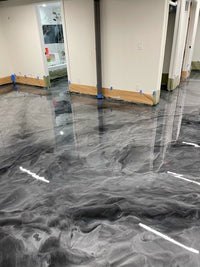Thumbnail for Modern silver and grey metallic epoxy floor with a high-gloss reflective finish and custom flowing marble patterns using Metallic Dream 100% solids epoxy.